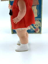 Load image into Gallery viewer, Side view of the 1967 Mattel Walk n Play doll in a red dress with a box background.
