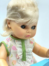 Load image into Gallery viewer, Close-up detail of the Mattel Tippee Toes doll's face with blue eyes and blonde hair.
