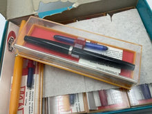Load image into Gallery viewer, Walker Fly vintage fountain pen set featuring empty packaging with various pens inside.
