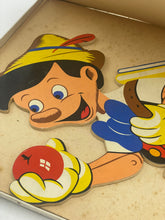 Load image into Gallery viewer, Detail of a Pinocchio puzzle piece featuring a smiling character holding a ball.
