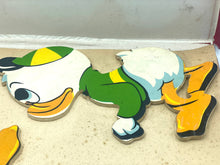 Load image into Gallery viewer, Detail of a green and yellow Donald Duck puzzle piece.
