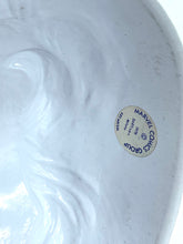 Load image into Gallery viewer, Detail close-up of ceramic plate with embossed design and manufacturer mark.
