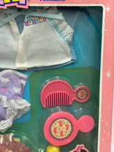 Load image into Gallery viewer, Detail close-up of small toys with colorful designs in pink and purple.
