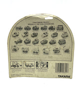 Load image into Gallery viewer, Top view of the TAKARA Penny Planes toy in transparent packaging.
