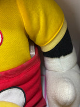 Load image into Gallery viewer, Close-up of colorful design on yellow plush toy with red and black accents.
