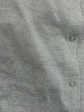 Carica l'immagine nel visualizzatore di Gallery, Detail view of gray fabric highlighting button detail and texture.
