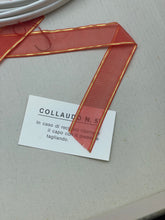 Carica l'immagine nel visualizzatore di Gallery, Ferrari Mazzini close-up of a flat red ribbon with printed tag.
