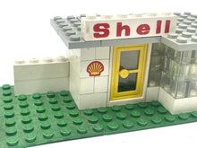 Carica l'immagine nel visualizzatore di Gallery, Front view of LEGO Shell gas station showcasing the Shell logo and glass windows.
