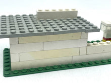 Carica l'immagine nel visualizzatore di Gallery, Side view of LEGO Shell gas station highlighting the transparent wall and green base.
