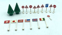 Carica l'immagine nel visualizzatore di Gallery, LEGO 939 detail close-up of miniature Christmas trees and flags in green, red, and white.
