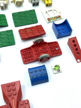 Carica l'immagine nel visualizzatore di Gallery, LEGO 70's Fabuland colorful building blocks and small figures in red, blue, green, and yellow.
