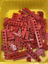 Carica l'immagine nel visualizzatore di Gallery, Collection of red building blocks in different shapes on a solid color background.

