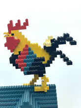 Carica l'immagine nel visualizzatore di Gallery, Detail of a colorful rooster figure in a standing pose.
