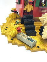 Carica l'immagine nel visualizzatore di Gallery, Detail view of the LEGO house base showing various pieces and steps.
