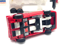 Load image into Gallery viewer, Bottom view of Takara Transformers G1 Sideswipe revealing wheel details and battery compartment.
