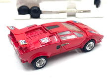 Load image into Gallery viewer, Side view of Takara Transformers G1 Sideswipe showing detailed design with silver accents.
