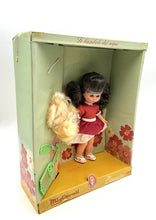 Load image into Gallery viewer, Migliorati Bambola Vania doll in box with black hair and floral background.
