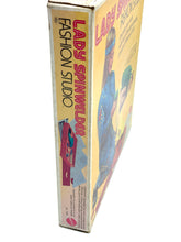 Load image into Gallery viewer, Mattel 1974 Lady Spinwelder Fashion Studio Kit side view showcasing the game title and colorful design.
