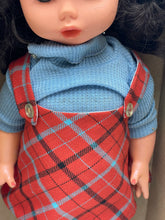 Carica l'immagine nel visualizzatore di Gallery, Detail view of Italocremona doll's outfit featuring a plaid dress and blue top.
