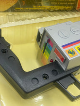 Load image into Gallery viewer, Detail view of a black and yellow printer cartridge with plastic body and color labels.
