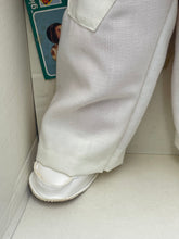 Load image into Gallery viewer, Close-up of Sebino Doll's foot highlighting sneaker style with shiny surface.
