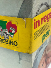 Load image into Gallery viewer, Detail of Sebino Doll packaging showing logo and text detail in red and yellow.
