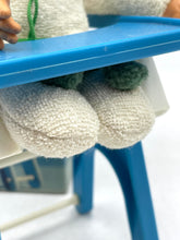 Load image into Gallery viewer, Detail of Vintage Sebino Ciccinobello Bimbo Giallo's white plush feet with green pom-poms.
