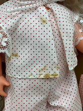 Load image into Gallery viewer, Detail of Sebino doll's outfit featuring a polka dot pattern and lace trim.
