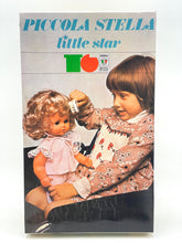 Load image into Gallery viewer, Sebino doll packaging front view featuring colorful text and a child with a doll.
