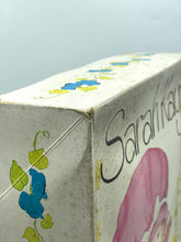 Load image into Gallery viewer, Side view of the packaging edge with decorative elements and text.
