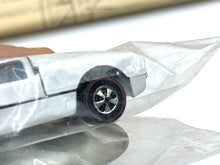 Load image into Gallery viewer, Detail close-up of another toy car in plastic packaging with detailed wheels.

