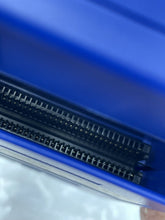 Load image into Gallery viewer, Detail view of the blue storage box featuring ventilation holes and plastic material.
