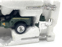 Load image into Gallery viewer, In-packaging shot of the military toy vehicle showcasing its design.
