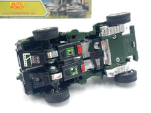 Load image into Gallery viewer, Bottom view of the military toy vehicle displaying the detailed undercarriage and battery compartment.
