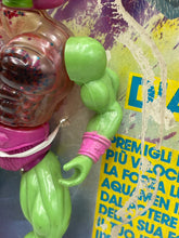 Carica l'immagine nel visualizzatore di Gallery, Detail view of the green action figure arm showcasing muscular design and pink wristband.
