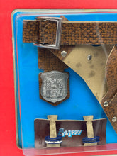 Load image into Gallery viewer, Close-up detail of the brown holster and silver badge with fasteners.
