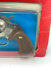 Load image into Gallery viewer, Close-up of the revolver toy featuring a metallic finish and wooden grip.
