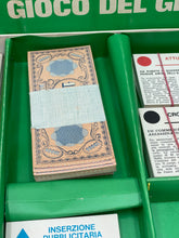 Load image into Gallery viewer, 1967 scoop! board game money detail featuring a stack of game currency in brown, blue, and white.
