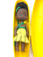 Load image into Gallery viewer, Lifestyle shot of the doll inside a banana wearing a tropical outfit.
