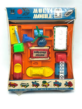 Load image into Gallery viewer, Tomy Jouets Mont Blanc Multi mobile packaging view with colorful design and brand logo.
