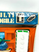 Load image into Gallery viewer, Close-up of Tomy Jouets Mont Blanc Multi mobile packaging showcasing colorful pieces and brand logo.
