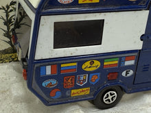 Load image into Gallery viewer, Side view of the blue camper trailer featuring various stickers
