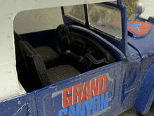 Load image into Gallery viewer, Detail close-up of the blue toy truck interior featuring steering wheel and seats.
