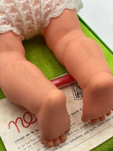Load image into Gallery viewer, Detail shot of Sebino Nella doll's chubby pink feet on a smooth surface.
