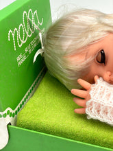 Load image into Gallery viewer, Close-up view of Sebino Nella doll's head with a hand positioned near it.
