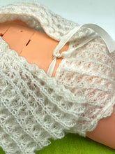 Load image into Gallery viewer, Lifestyle shot of a baby on a green surface wearing a crocheted outfit.
