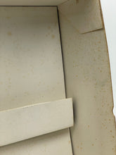 Load image into Gallery viewer, Detail view of a beige wooden box with a smooth surface and slight imperfections.
