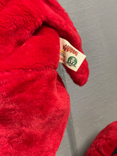 Load image into Gallery viewer, Gabibbo costume red plush tag detail with green accents on a solid background.
