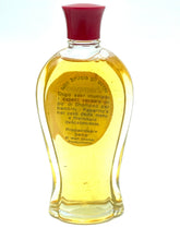 Load image into Gallery viewer, Detail close-up of yellow liquid bottle for Paperino's Shampoo showing transparent liquid.
