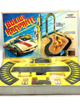 Load image into Gallery viewer, Packaging view of Tyco slot car racing set displaying track pieces and car models.
